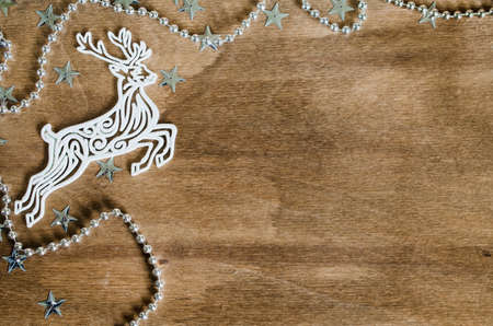 Christmas Background for Holiday Card in Rustic Style. Xtmas Decorative Deer on Wooden Board. Copy Space for Your Text. Toned image.の写真素材