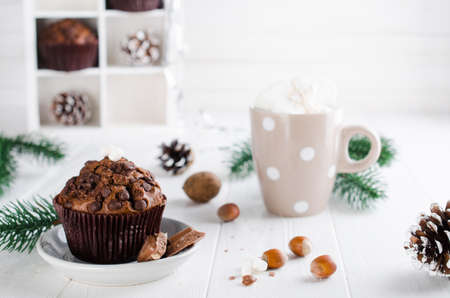 Christmas chocolate muffin and cocoa with marshmallow on white table. Xmas decoration. Selective Focus. Copy spaceの写真素材