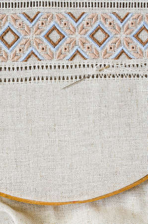 Embroidery design by brown and beige cotton threads on flax. Design of ethnic ornament. Background with embroidery texture. Hemstitch.の写真素材
