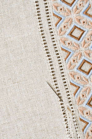 Embroidery hoop with fragment embroidered fabric. Design of ethnic pattern. Embroidery texture flat stitch and hemstitch.の写真素材