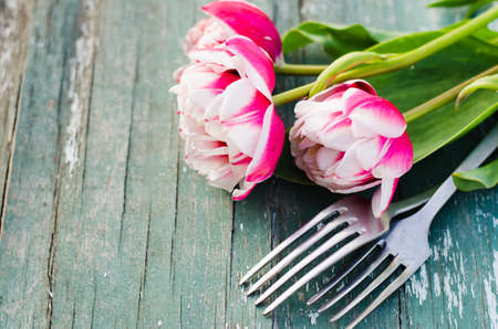 Festive Table Setting With Pink Tulips. Holiday Table Set for Mother's Day or Birthday. Selective Focus.の写真素材