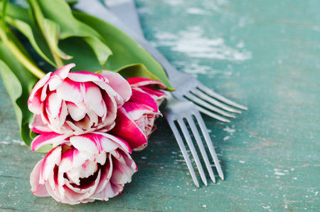 Festive Table Setting With Pink Tulips. Holiday Table Set for Mother's Day or Birthday. Selective Focus.の写真素材