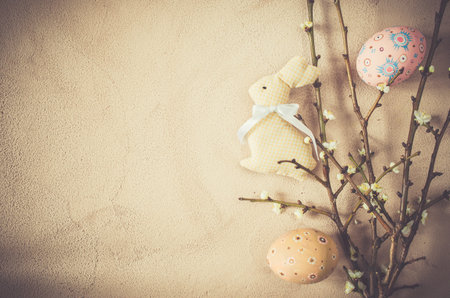 Easter background in vintage style with spring flowering branches and easter eggs. Top view, copy...