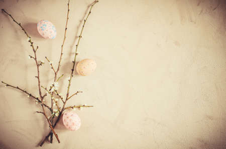 Easter background in vintage style with spring flowering branches and easter eggs. Top view, copy space.の写真素材