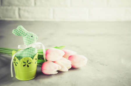 Happy Easter composition. Easter bunny, eggs and tulips. Space for textの写真素材