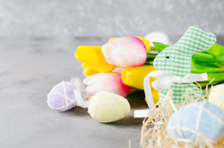 Happy Easter composition. Easter bunny, eggs and tulips. Space for text