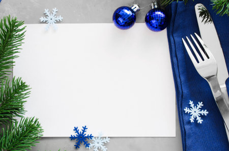 Background for writing the Christmas Menu. Winter Table Setting. Christmas tree, cutlery and blank paper. Top View, Copy Space.の写真素材