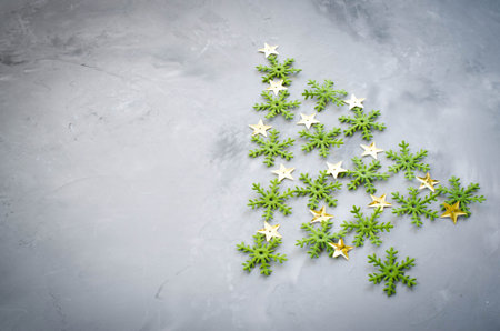 Christmas greeting card with place for your text. Decorative green snowflakers laid in the form of a...