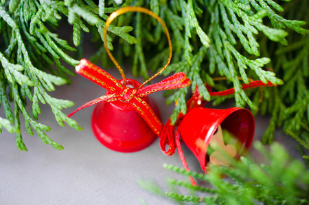 Christmas background with xmas fir branches and red bells. Christmas banner.