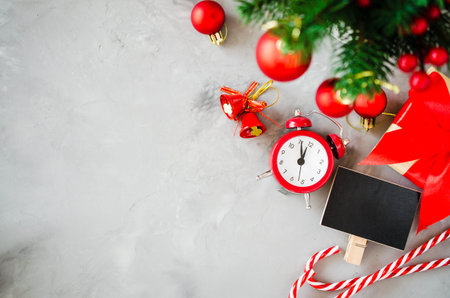 Christmas composition: xmas fir branches, alarm clock, gift box and decorations. Christmas still...