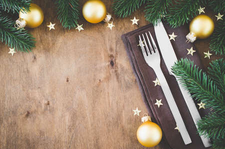 Background for writing the Christmas Menu. Winter Table Setting. Christmas tree, cutlery and fir branches. Top View, Copy Space.の写真素材