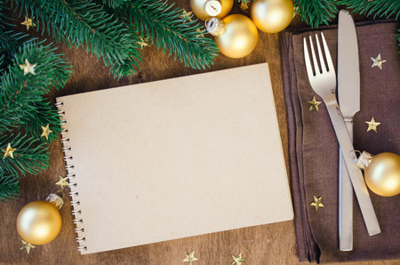 Christmas table place setting for dinner with notebook