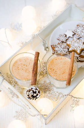 Christmas Traditional Homemade Eggnog and Gingerbread Cookies on White Background. Christmas Milk Cocktail with Spice. Selective Focus. Copy Space.の写真素材