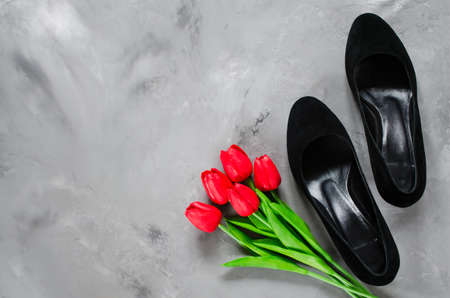 Classic black womens black shoes and red tulips.の写真素材
