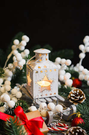Christmas still life with lantern, gift box and xmas decorations on wooden background.の写真素材