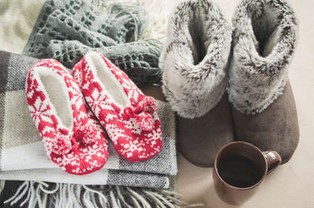 Warm home clothes. Woolen plaid and home slippers and cup of hot drink.の写真素材