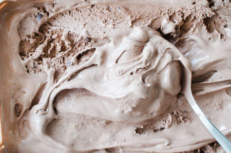 Texture of melting chocolate ice cream. Brown background, close upの写真素材