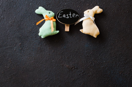 Easter background with decorative rabbit and inscription Easter. Holidays background with Easter...