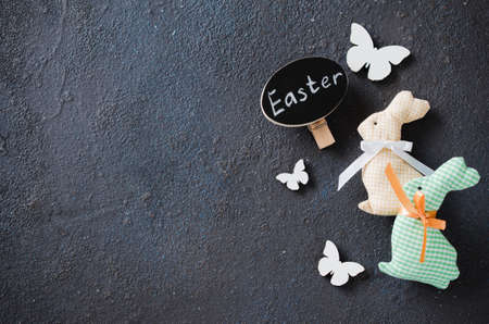 Easter background with decorative rabbit, butterflies and inscription Easter. Holidays background with Easter decorations and copy space.の写真素材