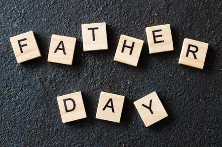 Father's day concept. Wooden letters on dark background. Top view.の写真素材