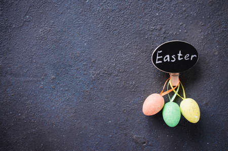 Easter background with decorative eggs and inscription Easter. Holidays background with Easter decorations and copy space.の写真素材