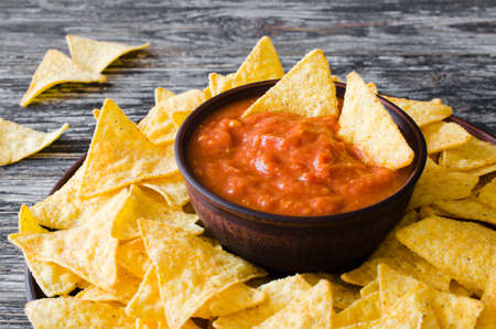 Nachos corn chips with spicy tomato sauce.の写真素材