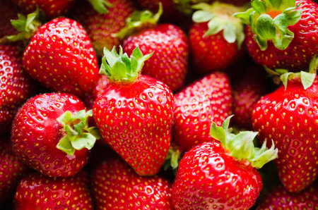 Background of fresh ripe strawberries macro. Organic juicy berries. Top view. Copy space for your...