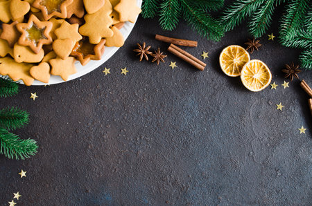 Christmas and culinary background with a plate of freshly baked Christmas gingerbread, spices and...