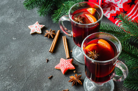 Christmas background with mulled wine, spruce branches and a warm winter scarf.の写真素材