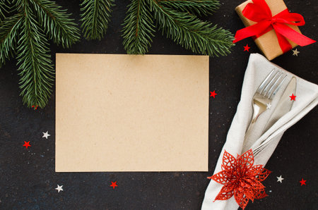 Christmas table setting. Winter background for writing the Christmas or New Year Menu. Christmas tree, cutlery and and blank paper. Top view or flat lay. Copy Space.の写真素材