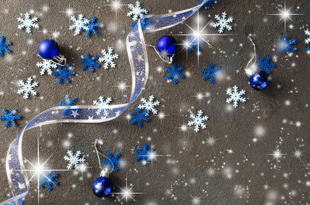 Silver Christmas background. Curly ribbon with decorative balls and snowflakes. Xmas decorations.