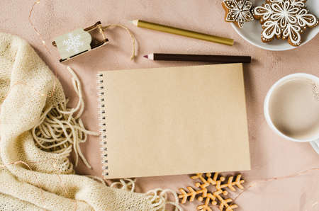 Flat lay of blank brown notebook with Christmas decoration and plaid. Christmas mock up for greeting card or letter to Santa. Cozy winter mood. Copy space.の写真素材