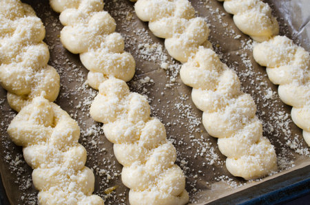 Preparation process - raw unbaked buns. Yeast dough buns on baking paper, close-up. Rustic style....