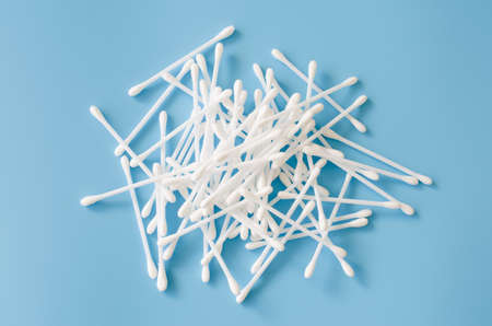 Cosmetic cotton buds on blue background. Sticks for cleaning ears. Top view.の写真素材