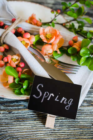 Festive table place setting with spring blossoming branch on wooden background. Copy spaceの写真素材