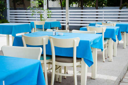 Cozy summer cafe. Tables and chairs on outdoor terrace. Empty street cafe or restaurant.の写真素材