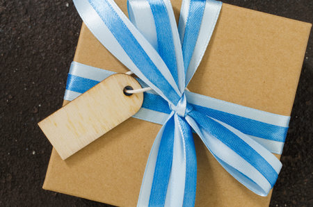 Gift box with empty tag. Mockup of greeting card for Father's or Grandfather's Day. Top view with space for your text. Flat layの写真素材