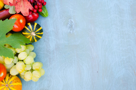 Seasonal fruits and vegetables on blue background. Autumn harvest. Thanksgiving dinner