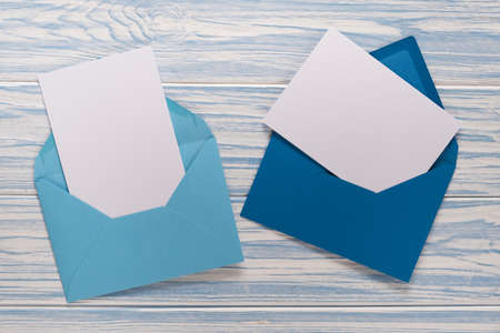 Empty Christmas card, envelopes with template letter on blue woodenの写真素材