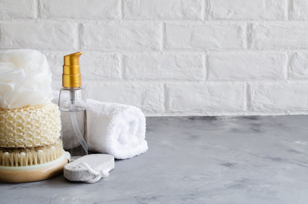 Spa wellness setting concept. Spa accessories on gray concrete background. Towel, massage brush, pumice. Flat Lay, top view. Copy spaceの写真素材