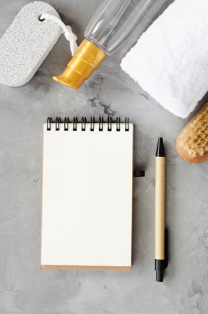 Spa wellness setting concept. Spa accessories on gray concrete background. Towel, massage brush, pumice. Flat Lay, top view. Copy spaceの写真素材