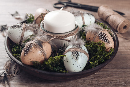 Spring decor ideas Diy. How to make Easter floral arrangement with decorative eggs, candle and moss....
