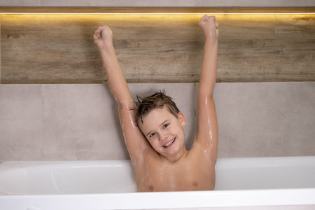 Happy wet nude boy in bathroom Smiling Child bathes at home