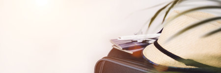 Lifestyle and traveling concept after quarantine Passports, hat and model airplane on gray suitcase