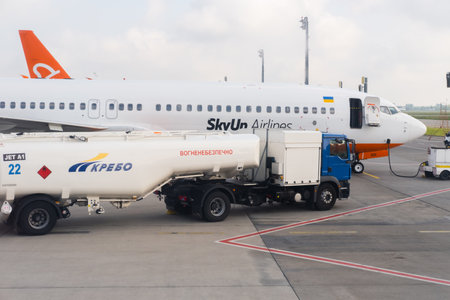 Kyiv, Ukraine - May 27, 2021 Truck refueling an airplane SkyUp airlines on airport runway at Airport Boryspil.のeditorial素材