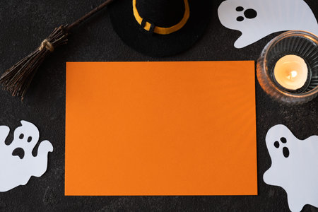 Template for Halloween with decorative witch attributes, cute ghosts and candle.