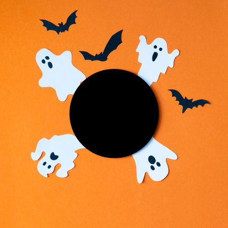 Template for Halloween with decorative cute ghosts and bats on orange background. Black circle...