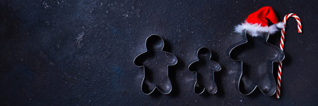 Christmas cookie cutters in shape of gingerbread mans. Happy family holidays concept.の写真素材