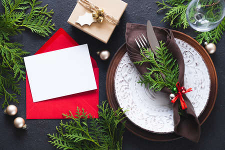 Christmas table setting with mockup of greeting card or invitation.の写真素材