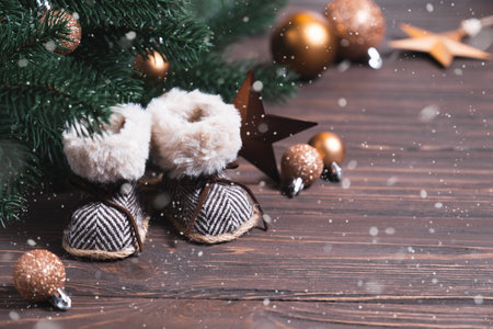 Christmas composition with decorative boots, decorations and pine branches.